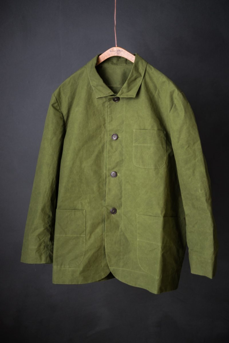 Garment in green fabric on hanger