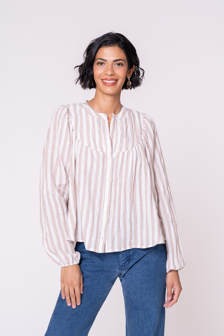 femme presenting white person wearing a yoked loose blouse