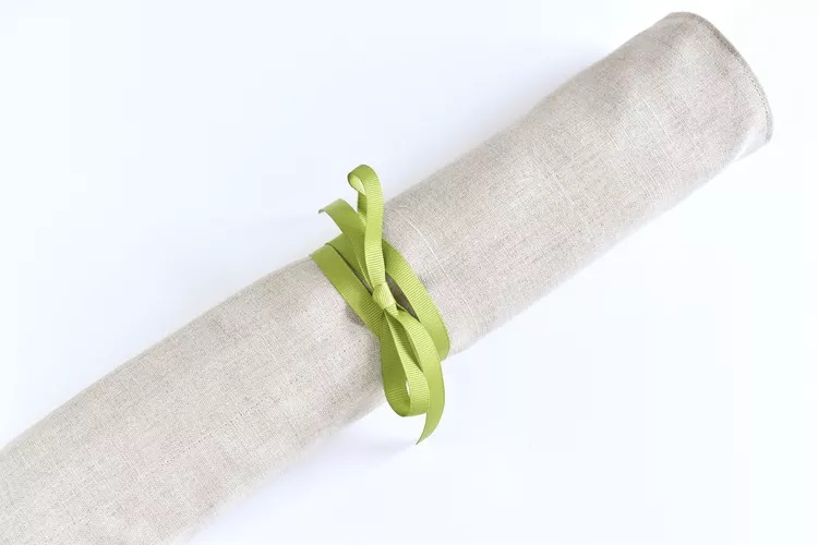 Needle case rolled up and closed with ribbon