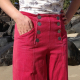 Model wearing pants showing detail of sailor button closure