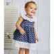 A toddler wearing a blue ruffled dress