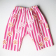Gathered waist, wide legged Basic Newborn Pant from Made by Rae, sewn in pink and white strip with overlaid modern floral motif.