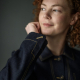 Close-up photo of the dark denim jacket showing the cuff and button/buttonhole band details.