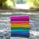 stack of Mariner Cloth by Alison Glass in various colors, sitting on gravel