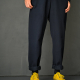 Below waist front view, dark blue twill, yellow shoes