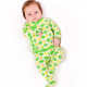A baby wearing a cross-front shirt and footed leggings in a green apple print against a white background.