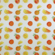 White fabric with a pattern of  yellow and orange citrus fruits