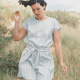 A person wearing a striped, blue and white playsuit