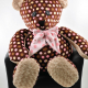 Brown polka dotted teddy bear with pink ribbon