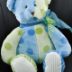 Multicolored teddy bear with ribbon on neck