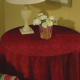 Small round end table with red tablecloth
