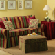 Living room with couch, ottoman, and end table covered in matching fabrics