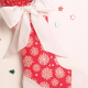 Red Christmas stocking with white ribbon