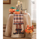 Picture of small round table with tablecloth, table runner, stuffed pumpkins, and a small fabric basket