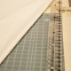 natural cotton fabric folded next to ruler and measuring board