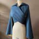 Blue hip length cape with cross over wrap front and collar, displayed on dressform