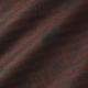 Close up of fabric showing a little bit of drape, color is deep rusty red with flowers in darker shades as well as small white flowers
