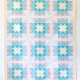 This quilt is made with all the blocks using the same solid fabrics for the same pieces. The blocks have a white square at the center, surrounded by a yellow star on a blue background. This center ohio star square is surrounded by light blue bars, and peach and grey flying geese. The corners are a very light grey and white background HST.