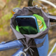 Cylindrical bag with drawstring closure hung off bicycle handlebars