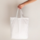 Arm holding a plain white rectangular tote bag