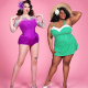 A white woman with dark hair, and tattoos on her arms, wearing a purple, sleeveless swimsuit and a black woman wearing a straw hat and a green and white, skirted swimsuit standing against a pink background.