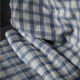 blue and white check fabric laid against dark grey background