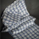 blue and white check fabric laid against dark grey background