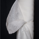 sheer white fabric in a roll against a black background