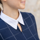thin brunette woman wearing a navy long sleeved shirt with a white contrast collar