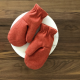 Photo from etsy page. Two red mittens, showing a seam over the thumb.