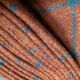 Showing orange tweed with teal check pattern