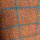 Showing orange tweed with teal check pattern