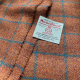 Showing orange tweed with teal check pattern nand Harris Tweed patch