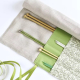 Needle case partially rolled up with needles inside the pockets