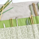 Needle case open with needles inside and outside the pockets