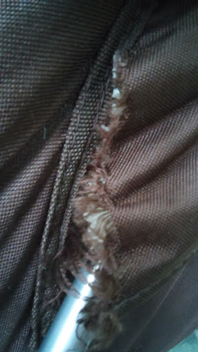 another close-up of where old butterfly chair cover fits over frame - frame is poking through, seams are ripped